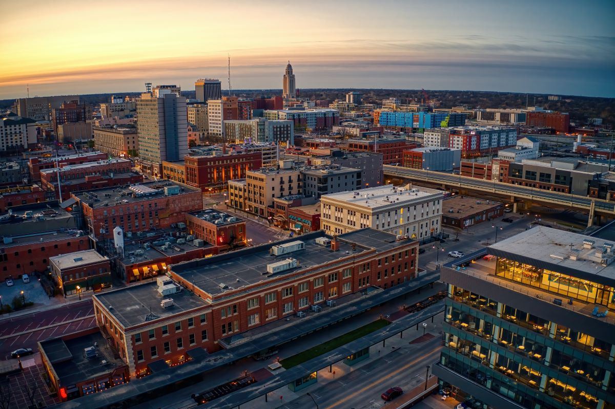 Aerial view of downtown Lincoln, Nebraska at sunset with the state capitol and city skyline